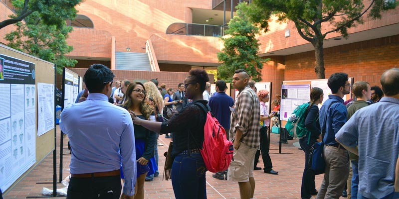 Conference attendees enjoy an outdoor poster session.