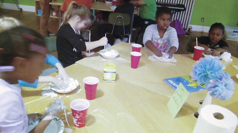 A Science Friday group making Oobleck. Photo courtesy of  Towson State University.