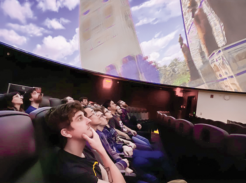 Students gaze up at the planetarium show on the first day of the Zone 18 meeting.