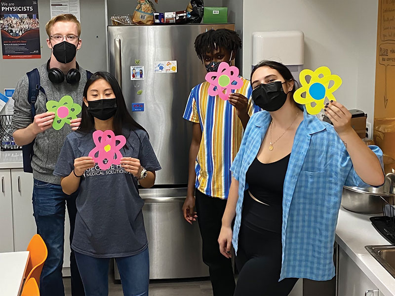 GW SPS board members Gabe Grauvogel, Marisa Lazarus, Addy Irankunda, and Davie Loria having fun with atoms. 