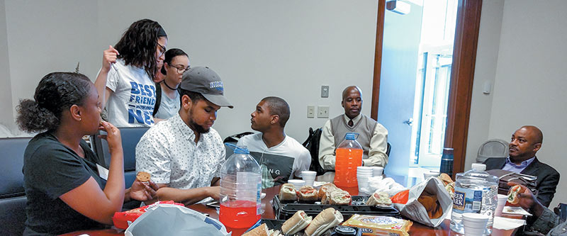  SPS advisor Paul Gueye (to the left of the door) and the Hampton University SPS chapter. Photo courtesy of Brad Conrad.