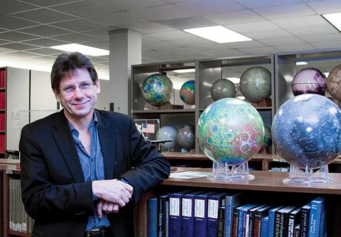 Steve Mackwell among the planetary globes in the library at the Lunar and Planetary Institute in Houston.