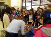 Christina Hammock of NASA autographs pictures for students.