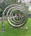 Amanda and I High-Fiving at the Spiral Sculpture in Front of the ACP Building, posing with our bikes