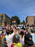 Photo of a float and the crowd at the pride parade