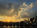 Photo of a sunset with boats on the water